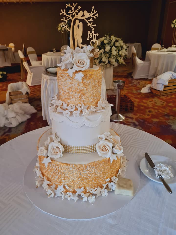 Gold lace 3-tier wedding cake with cascading sugar roses